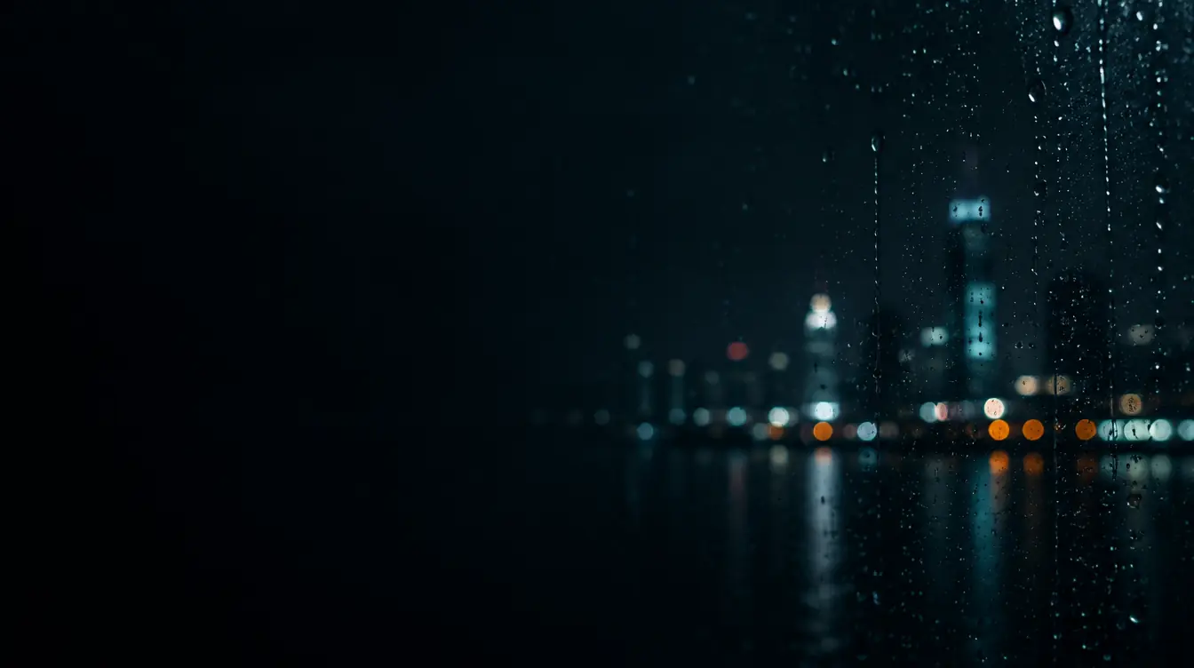 City lights blurred behind a rain-covered window at night
